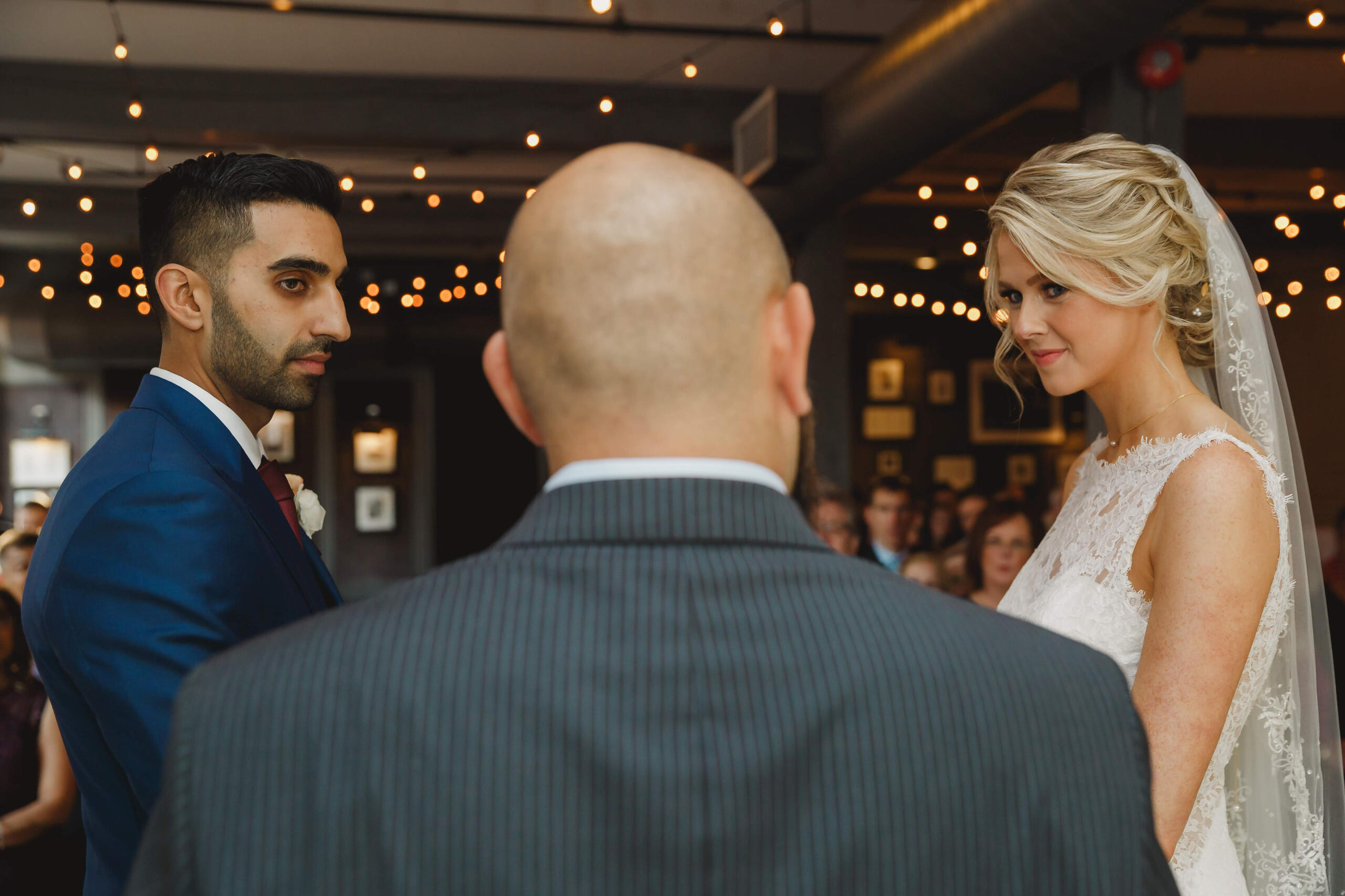 Couple getting married in a chich wedding hall by a humanist officiant.